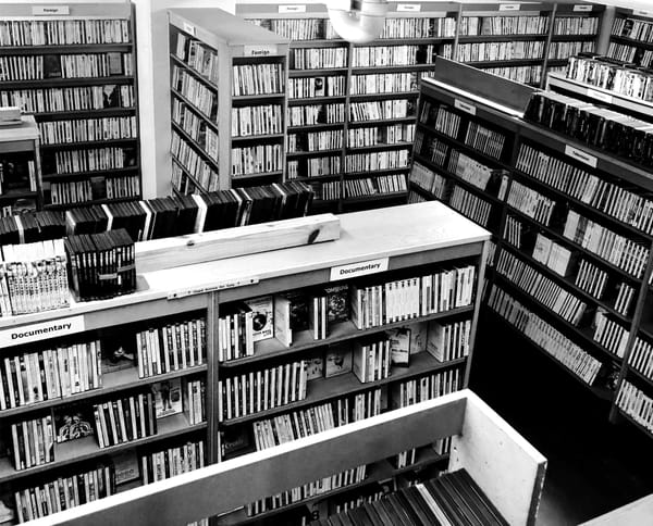 Looking down at a room filled with multiple wooden shelves filled with DVDs.