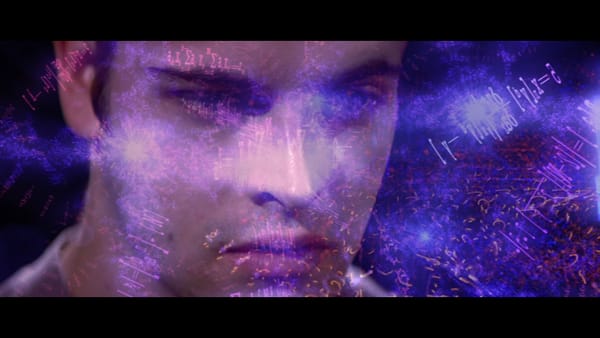 Screengrab from the 1995 movie “Hackers” shows Johnny Lee Miller’s face, with a flurry of equations superimposed over it.
